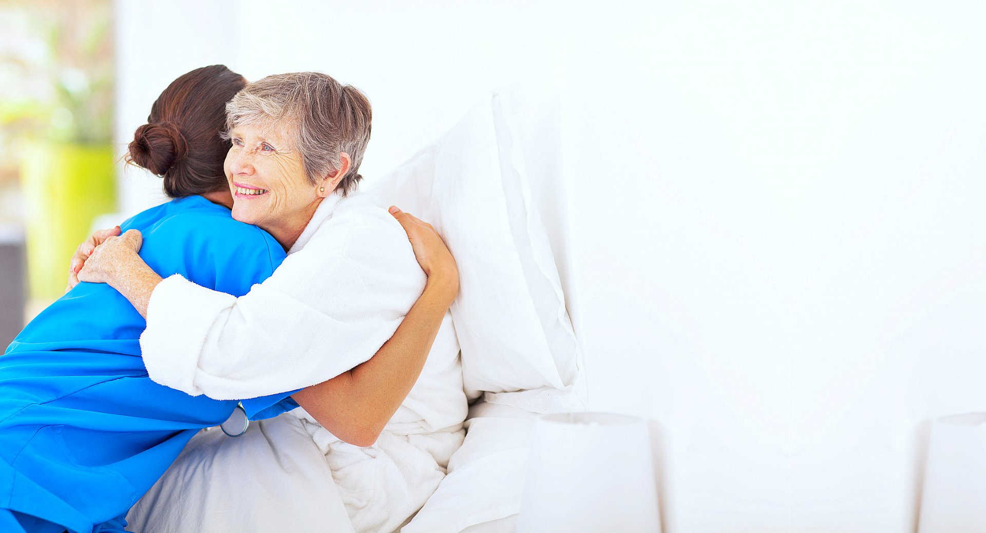 caregiver and senior woman hugging